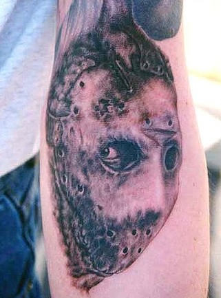 Strange Mask Tattoo On Arm