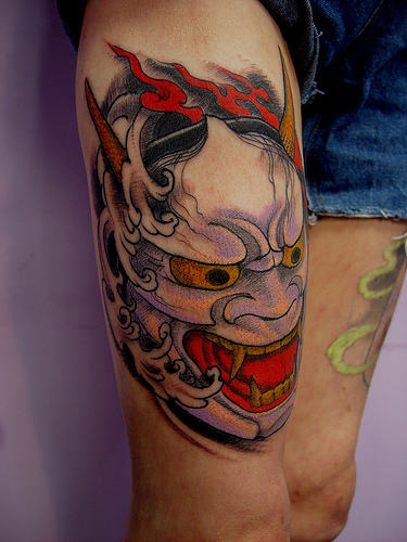 Mask Tattoo On Thigh