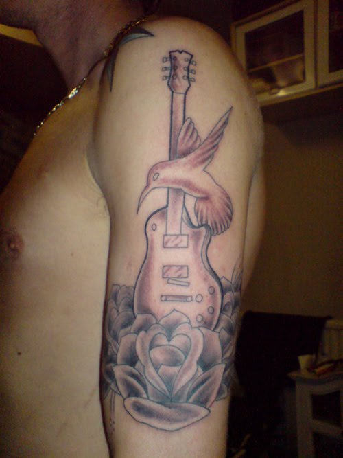 Guitar With Bird Tattoo On Arm