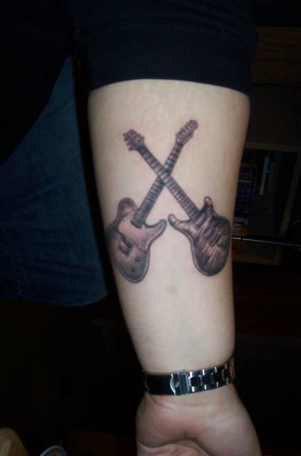 Guitars Tattoo On Arm