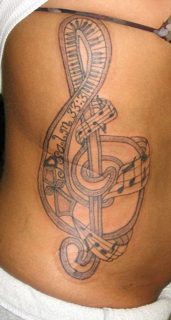 Big Music Tattoo On Rib