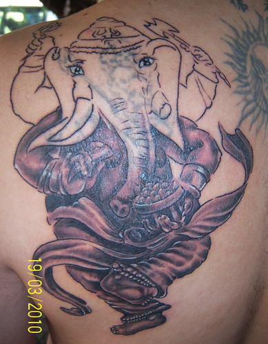 Amiable Ganesh Tattoo On Back
