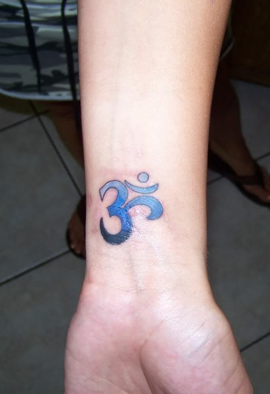 Blue Om Tattoo On Wrist