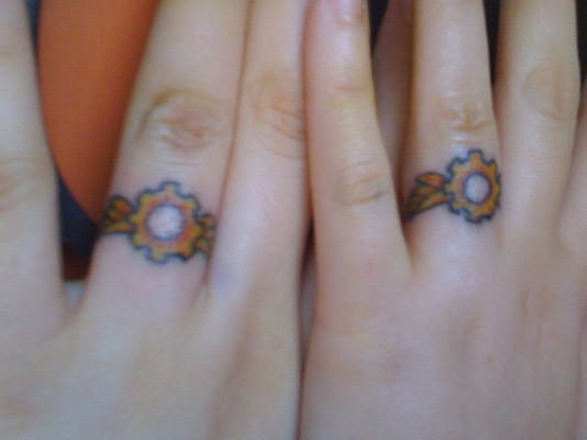 Yellow Rings Tattoo On Fingers