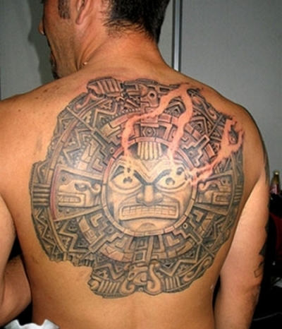Huge Strange Sun Tattoo On Back
