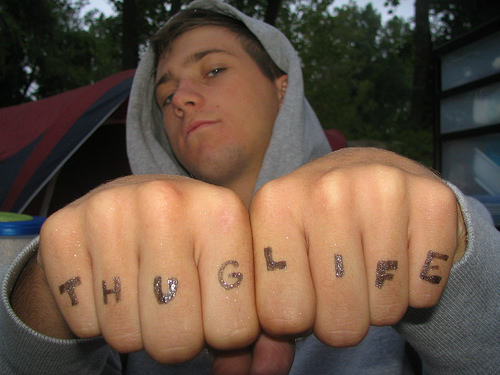 Guy Showing his Thug Life Tattoo