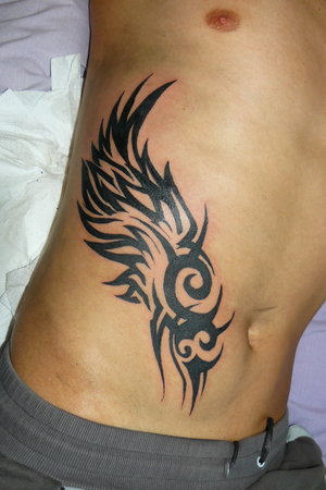 Tempting Tribal Tattoo On Rib