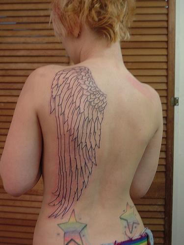Girl Showing her Single Wing Tattoo
