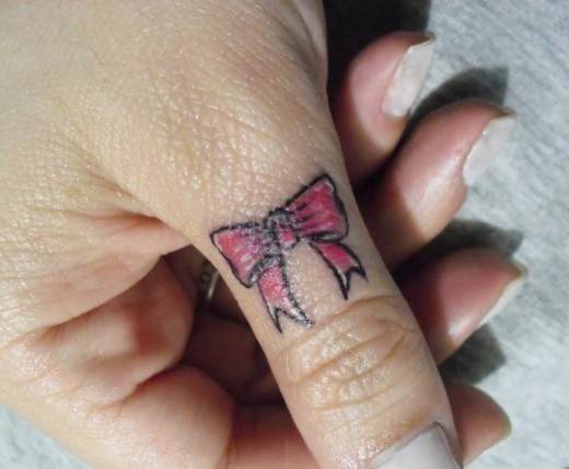Little Bow Tattoo On Thumb