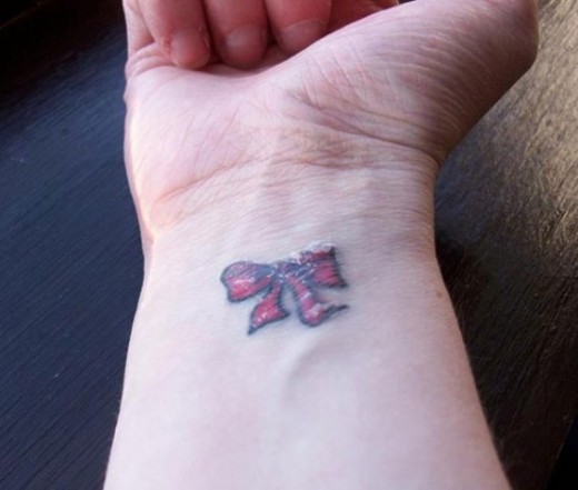 Little Bow Tattoo On Wrist