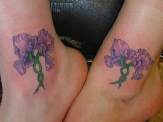 Purple Flowers Tattoo On Ankles