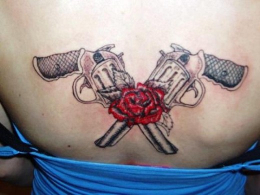Two Revolvers Tattoo On Back
