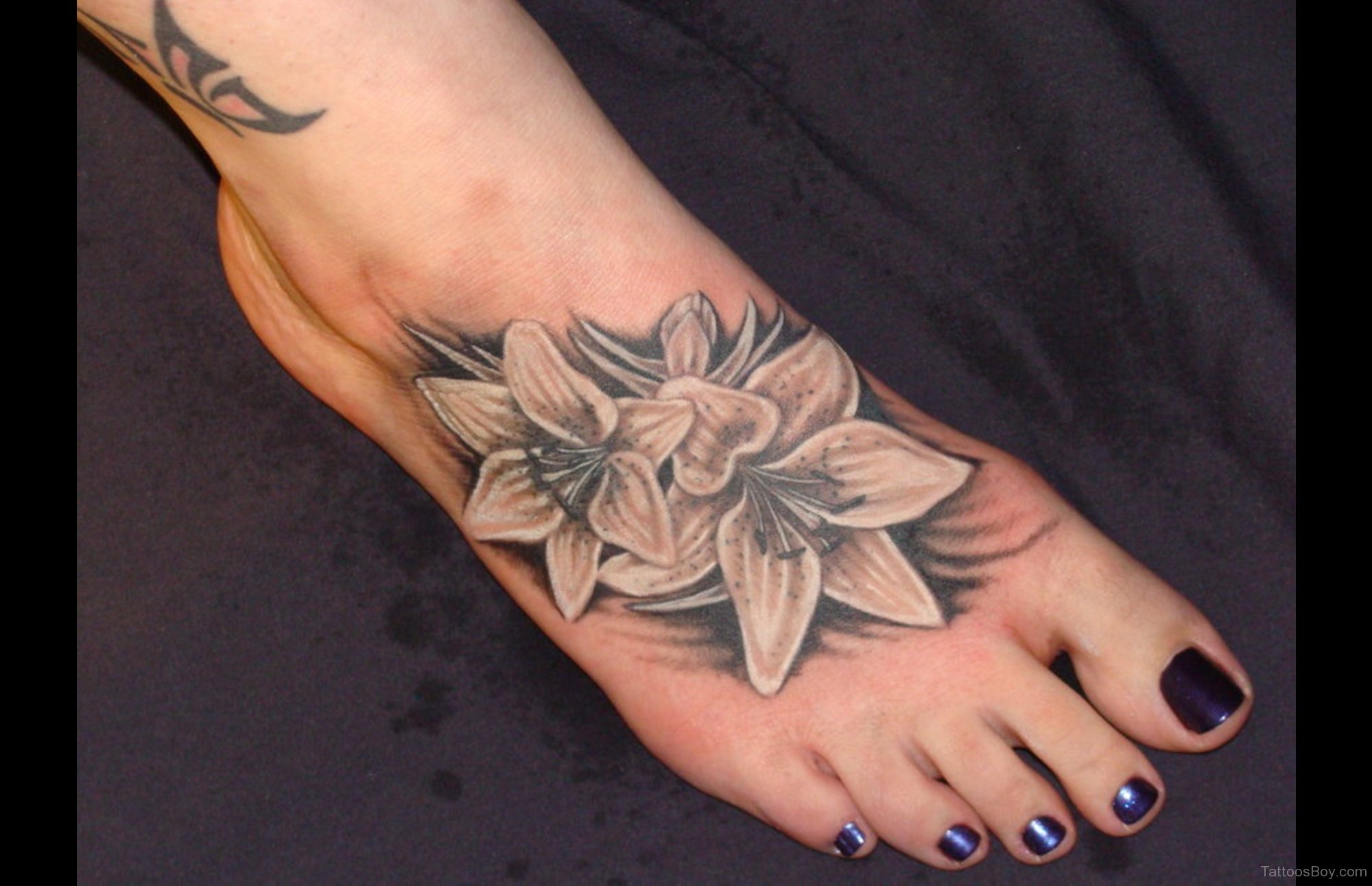 Violet flower tattoo on the ankle - Tattoogrid.net
