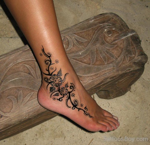 Black Ink Flower Tattoo On Ankle
