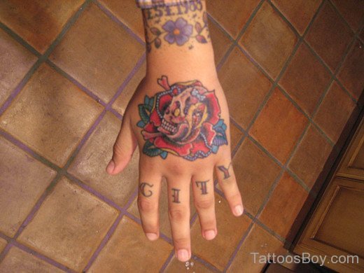 Admirable Rose Tattoo With skull On Hand