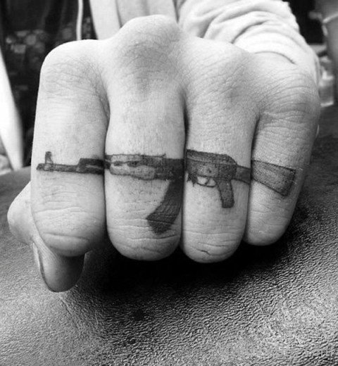 Gun Tattoo On Finger