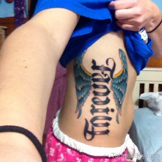 Ambigram And Wings Tattoo On Rib