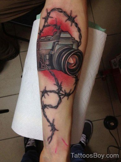 Camera And Barbed Wire Tattoo On Arm