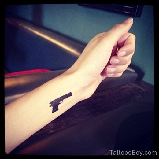 Black Gun Tattoo On Wrist