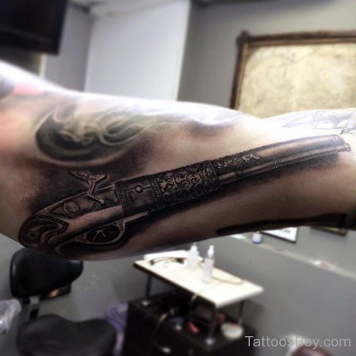 Old Gun Tattoo On Bicep